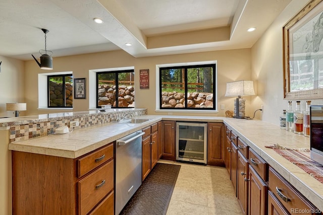 1250 Cottontail Trl, Woodland Park, CO 80863 - kitchen with beverage cooler, stainless steel dishwasher, brown cabinetry, a peninsula, and recessed lighting