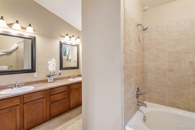 bathroom featuring tile patterned floors, vanity,  shower combination, and vaulted ceiling