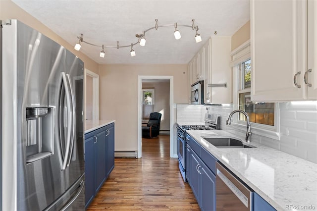 kitchen with sink, white cabinets, stainless steel appliances, and blue cabinets