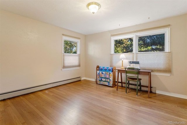 office featuring a baseboard radiator and light hardwood / wood-style flooring