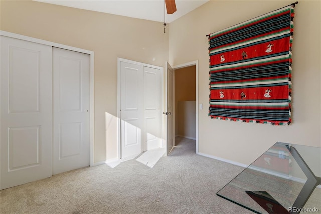 interior space featuring ceiling fan and carpet flooring