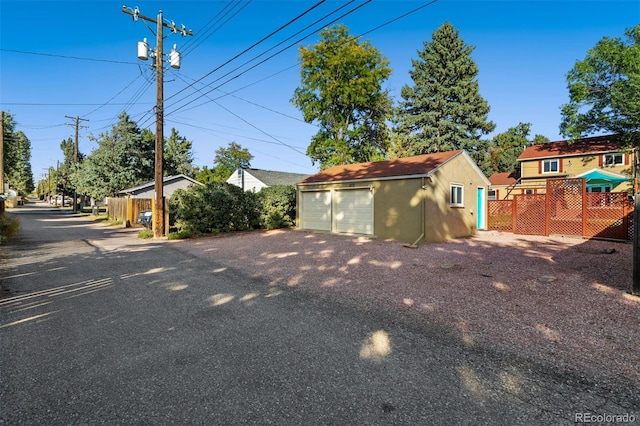 view of front of house with a garage and an outdoor structure