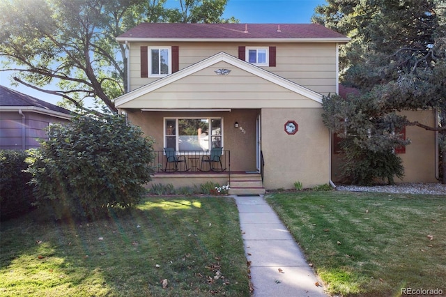 view of front facade with covered porch and a front lawn