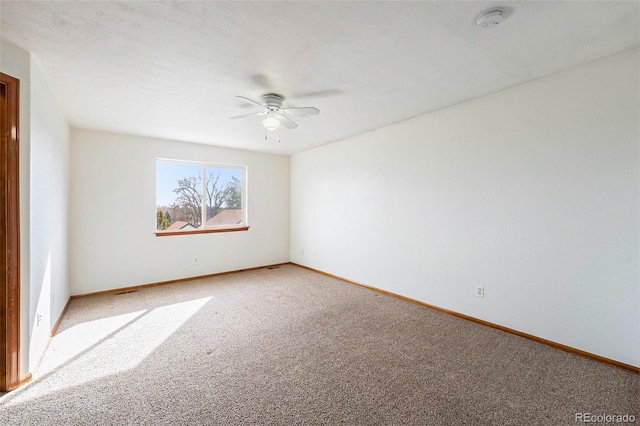 empty room with light carpet, baseboards, and ceiling fan