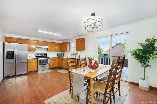 13504 Pecos St, Westminster, CO 80234 - dining area featuring light wood-style flooring and a chandelier
