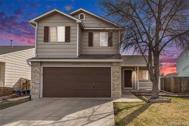 13504 Pecos St, Westminster, CO 80234 - traditional-style house featuring driveway, a garage, a porch, roof with shingles, and brick siding