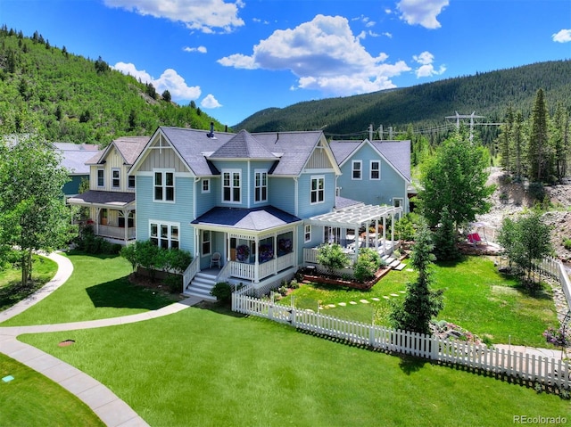 17 Meadow Lark Grn, Breckenridge, CO 80424 - view of front of home with board and batten siding, a pergola, a forest view, and a mountain view