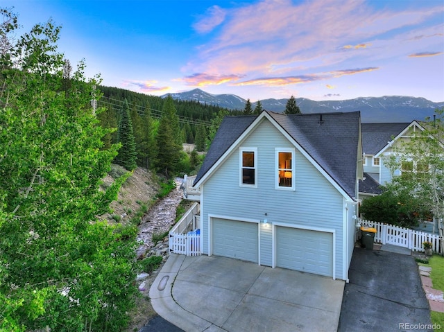 17 Meadow Lark Grn, Breckenridge, CO 80424 - view of side of property featuring a mountain view, an attached garage, driveway, and a shingled roof