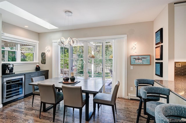 17 Meadow Lark Grn, Breckenridge, CO 80424 - dining room with wine cooler, wood finished floors, a baseboard heating unit, a bar, and a chandelier