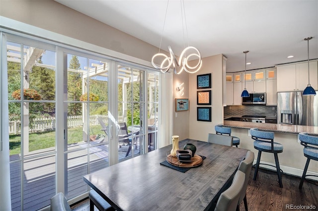 17 Meadow Lark Grn, Breckenridge, CO 80424 - dining space with healthy amount of natural light, dark wood-style floors, a chandelier, and recessed lighting