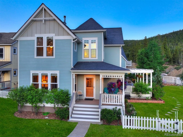 17 Meadow Lark Grn, Breckenridge, CO 80424 - view of front of home with a porch, board and batten siding, roof with shingles, and a forest view