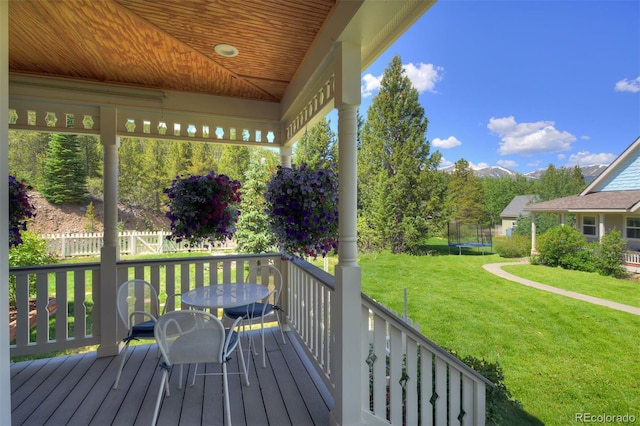 17 Meadow Lark Grn, Breckenridge, CO 80424 - deck featuring a trampoline, a lawn, and outdoor dining area