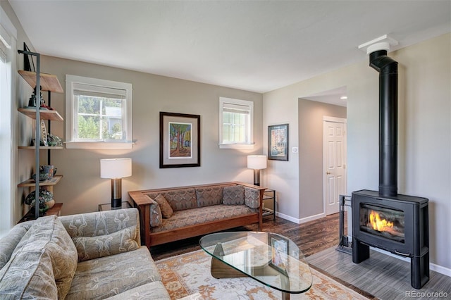 17 Meadow Lark Grn, Breckenridge, CO 80424 - living area with healthy amount of natural light, a wood stove, and wood finished floors