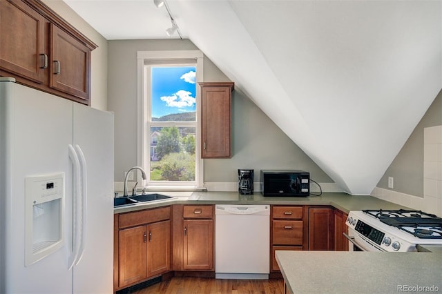 17 Meadow Lark Grn, Breckenridge, CO 80424 - kitchen with white appliances, light wood-style floors, rail lighting, brown cabinetry, and vaulted ceiling