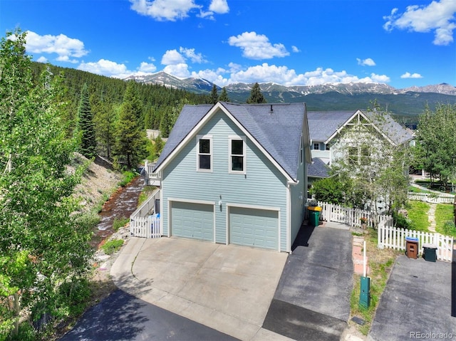 17 Meadow Lark Grn, Breckenridge, CO 80424 - view of front of home featuring a garage, a mountain view, and concrete driveway