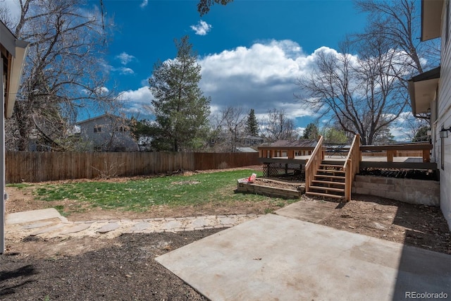 8170 S Marshall Ct, Littleton, CO 80128 - view of yard with a fenced backyard, a wooden deck, and a patio area