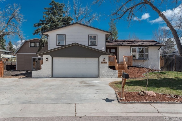 8170 S Marshall Ct, Littleton, CO 80128 - split level home with an attached garage, fence, driveway, and brick siding