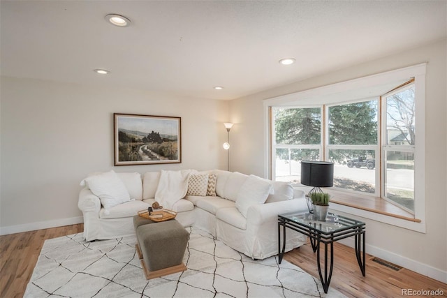 8170 S Marshall Ct, Littleton, CO 80128 - living room featuring recessed lighting, baseboards, visible vents, and light wood finished floors