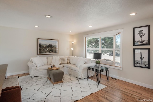 8170 S Marshall Ct, Littleton, CO 80128 - living area featuring baseboards, recessed lighting, wood finished floors, and visible vents