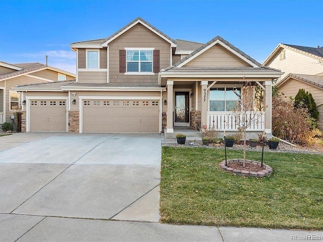 craftsman-style house with covered porch, a front yard, driveway, stone siding, and an attached garage