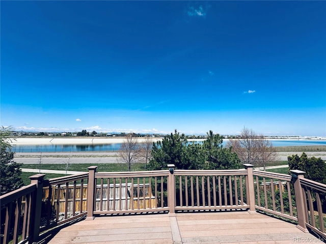 wooden terrace featuring a water view