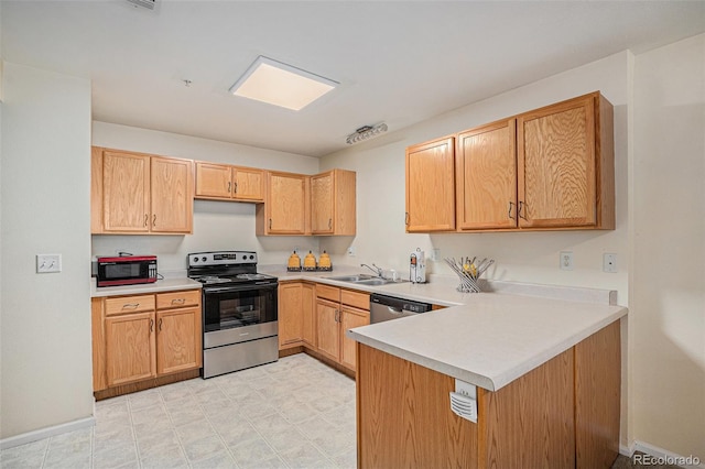 2900 Purcell St Unit 6, Brighton, CO 80601 - kitchen with stainless steel appliances, light countertops, a peninsula, and light floors