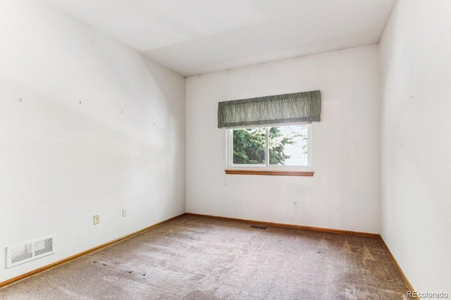 unfurnished room featuring visible vents, baseboards, and carpet