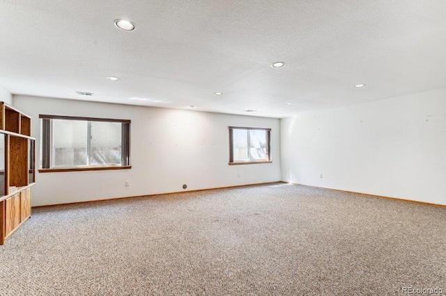 unfurnished room featuring recessed lighting, a textured ceiling, baseboards, and carpet floors