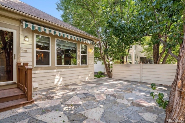 view of patio featuring fence