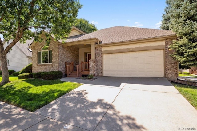 ranch-style house featuring a garage, a front yard, brick siding, and driveway