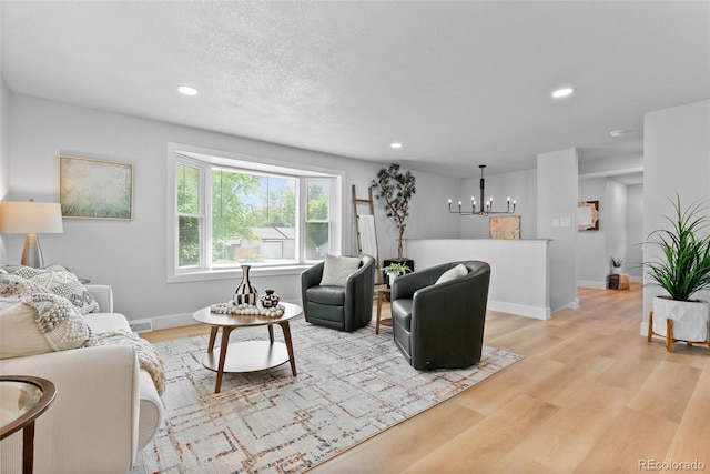 8333 Depew Way, Arvada, CO 80003 - living room featuring light wood-style flooring, recessed lighting, baseboards, and a chandelier