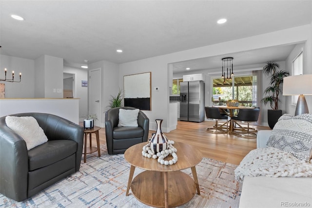 8333 Depew Way, Arvada, CO 80003 - living area with light wood-style flooring, recessed lighting, baseboards, and a chandelier