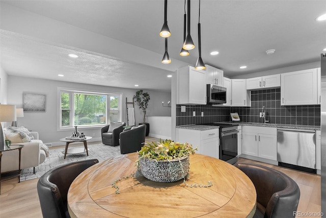 8333 Depew Way, Arvada, CO 80003 - dining space featuring light wood finished floors, recessed lighting, and baseboards