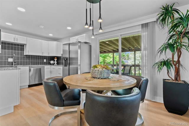 8333 Depew Way, Arvada, CO 80003 - dining area featuring light wood-style flooring and recessed lighting