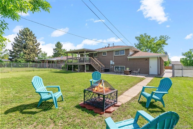 8333 Depew Way, Arvada, CO 80003 - rear view of house with an outdoor fire pit, stairway, brick siding, a wooden deck, and a patio area
