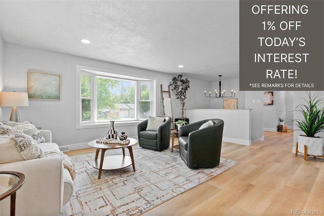 8333 Depew Way, Arvada, CO 80003 - living room with light wood-style floors, recessed lighting, a chandelier, and a textured ceiling