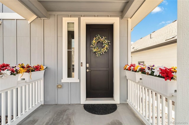 view of exterior entry featuring board and batten siding