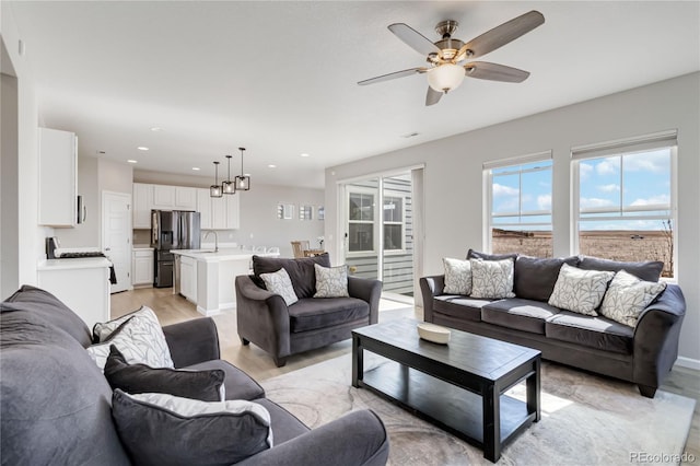 living area with recessed lighting, light wood-style floors, and ceiling fan