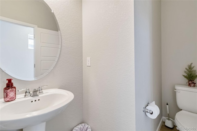 bathroom with toilet and a sink