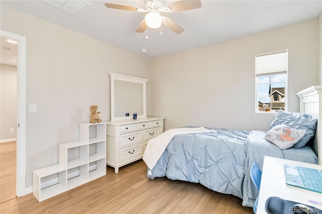 bedroom featuring ceiling fan, baseboards, and light wood-style floors