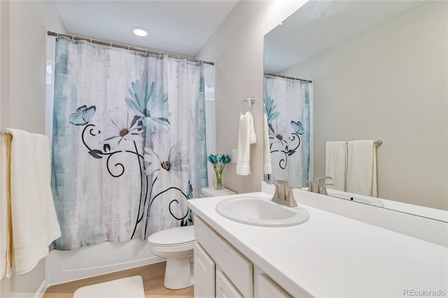 bathroom featuring vanity, toilet, and wood finished floors