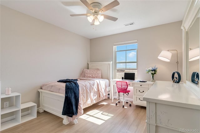 bedroom featuring a ceiling fan, visible vents, and light wood-type flooring