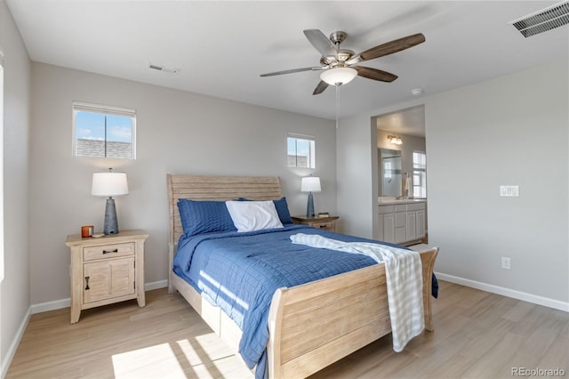 bedroom with light wood-style flooring, baseboards, and visible vents