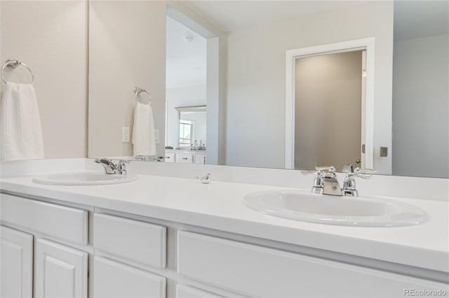 full bathroom featuring a sink and double vanity