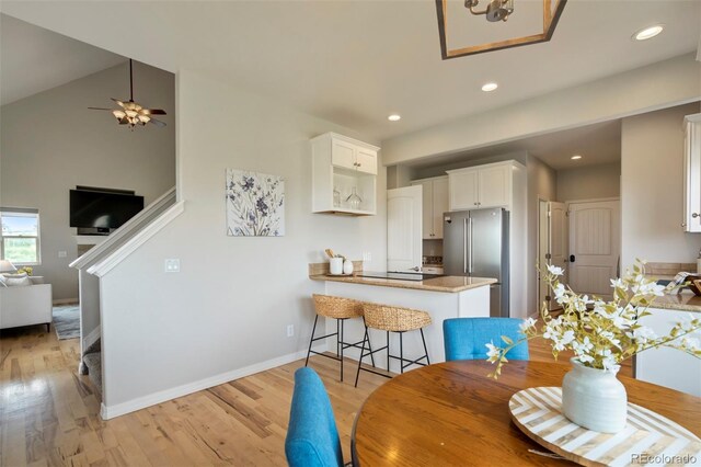 15580 Rigge Ct, Elbert, CO 80106 - dining area featuring light wood-style flooring, a ceiling fan, recessed lighting, baseboards, and high vaulted ceiling