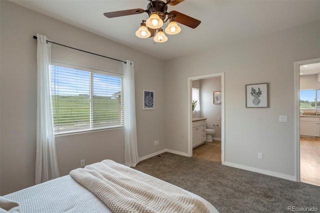 15580 Rigge Ct, Elbert, CO 80106 - bedroom featuring light colored carpet, baseboards, and ensuite bath
