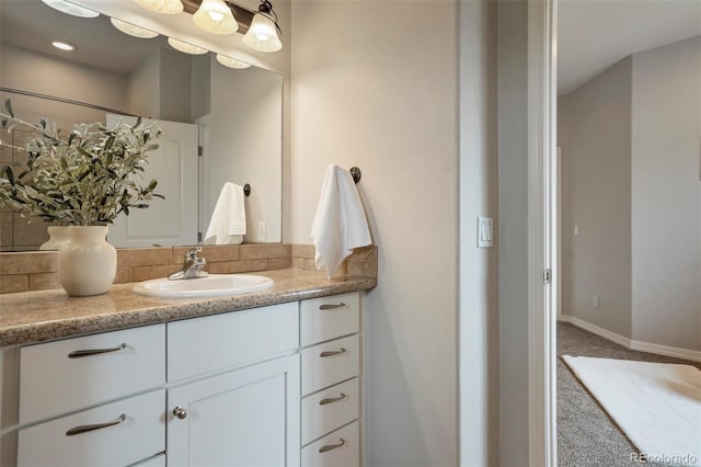 15580 Rigge Ct, Elbert, CO 80106 - bathroom with vanity, decorative backsplash, and baseboards