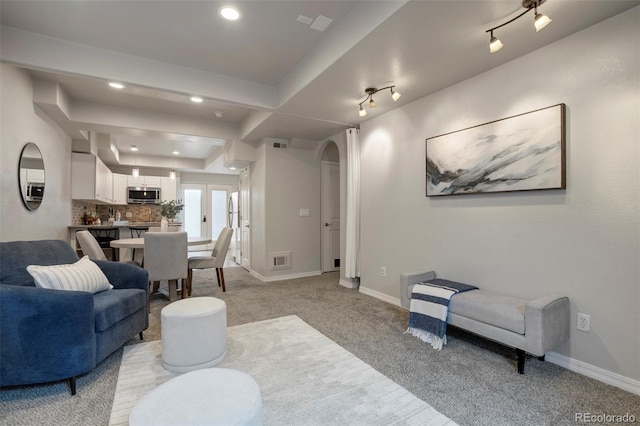 15580 Rigge Ct, Elbert, CO 80106 - living room featuring light colored carpet, arched walkways, recessed lighting, and baseboards