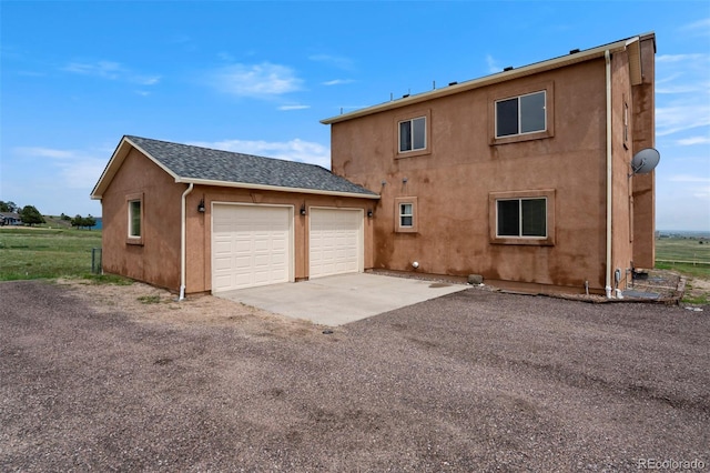 15580 Rigge Ct, Elbert, CO 80106 - back of house with stucco siding and a shingled roof