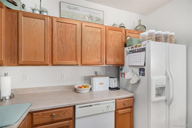 kitchen featuring white appliances and light countertops